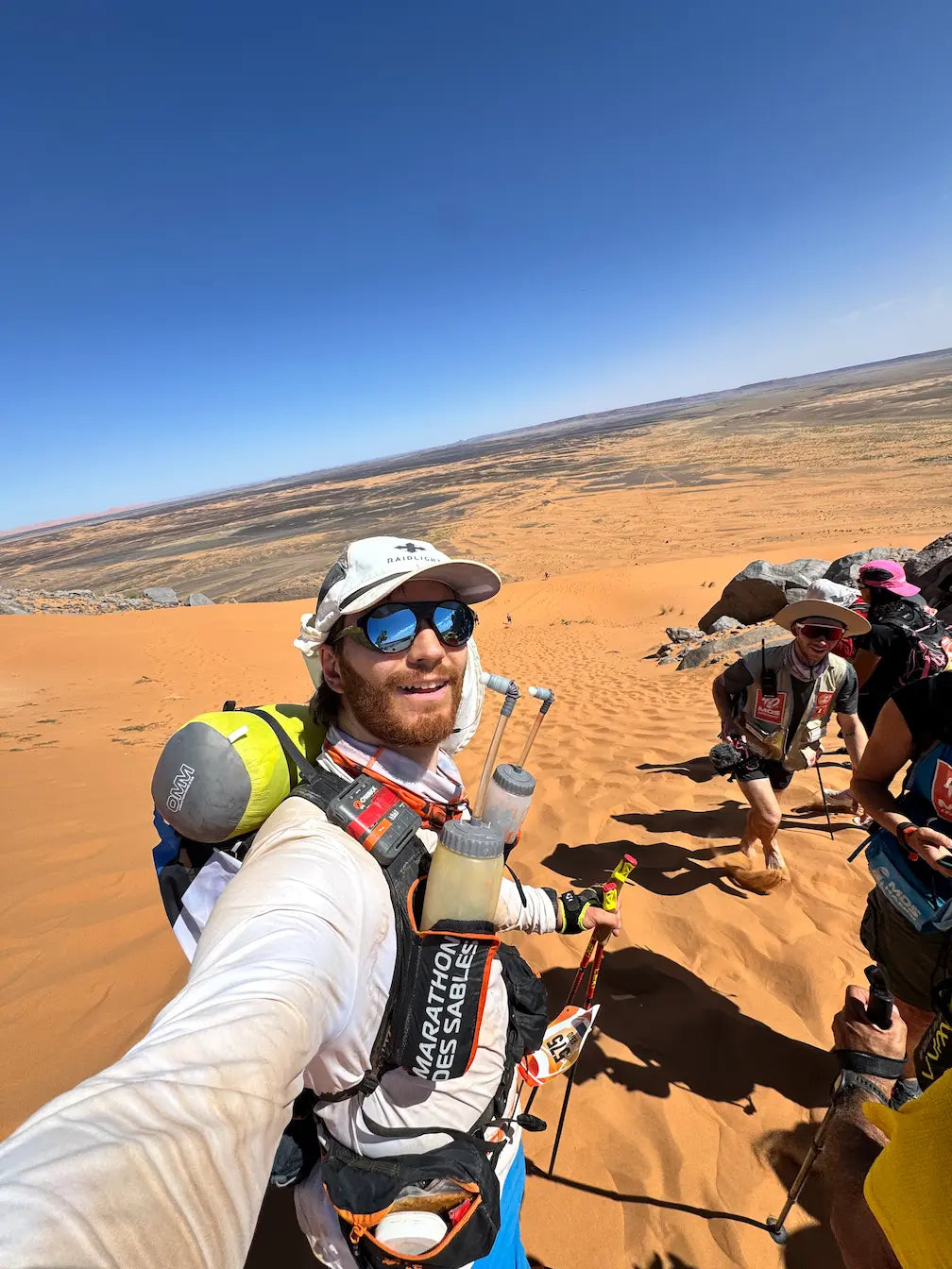Person crossing the Sahara Desert during a Marathon Des Sables 2026 endurance adventure